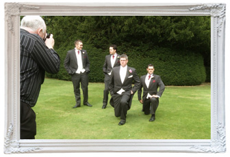 mick cookson their wedding photographer captures a fun moment of the groomsmen messing around doing lunges during the wedding at Mottram hall for the wedding video