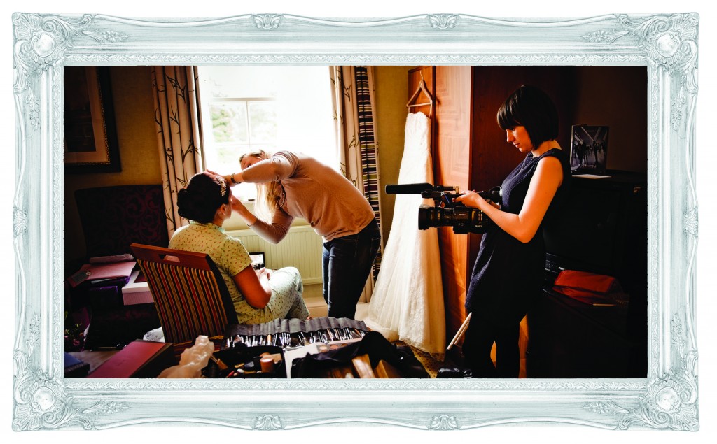 mick cookson takes a photo of a bride sitting in front of a large window at Mottram Hall in Cheshire having her bridal makeup done and being filmed by Charlene at Love Gets Sweeter who was her wedding videographer