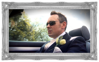 Groom wearing sunglasses and looking all cool driving wedding car Audi S4 for his own wedding video by love gets sweeter