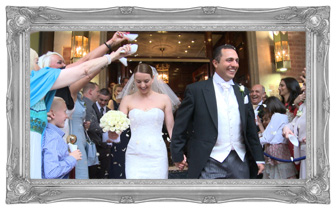 Bride wearing Stewart Parvin and Groom walk out holding hands and being showered in natural Confetti filmed outside The Chester Grosvenor Hotel and Spa by Love Gets Sweeter wedding videography in Cheshire