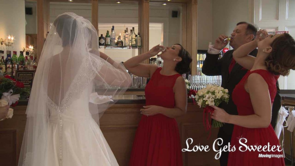 a wedding video still of the bride and her bridesmaids do a shot of whiskey at West Tower before they leave for the church in Lancashire