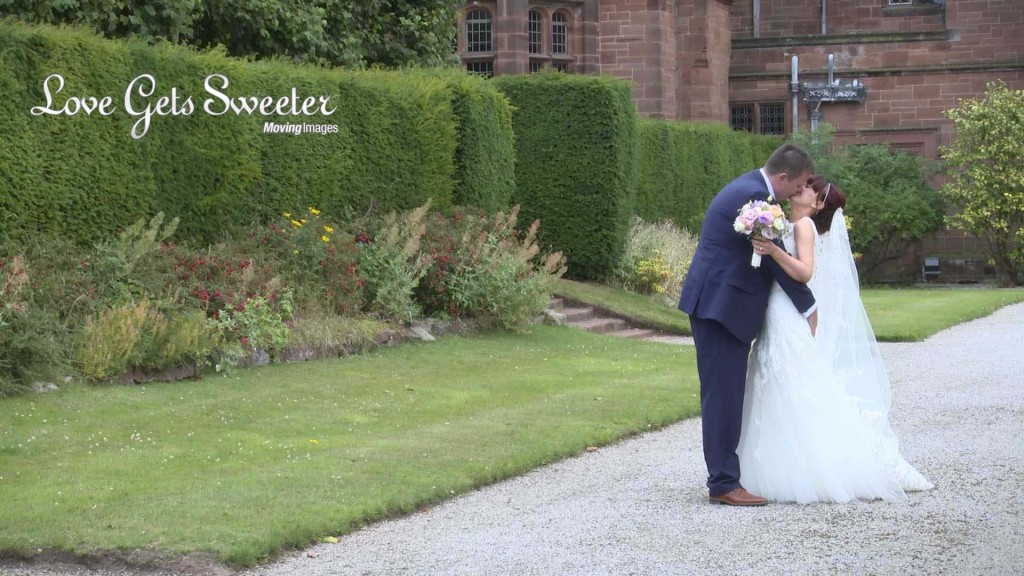 A bride grabs his brides bum and gives it a squeeze to make her laugh for the wedding video outside their wedding venue Thornton Manor