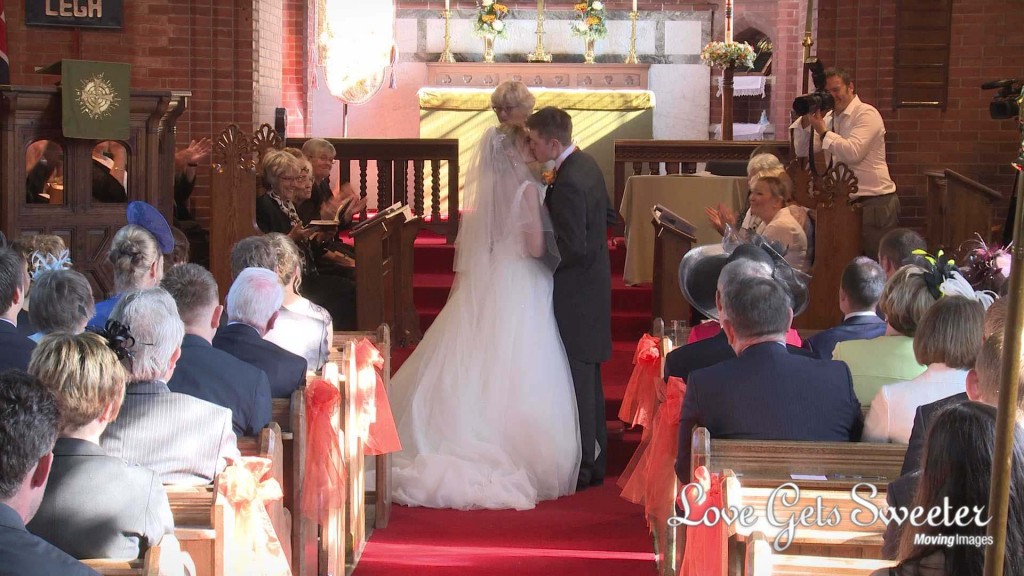 the bride and groom enjoy their first kiss as husband and wife for the wedding video at St Johns in High Legh