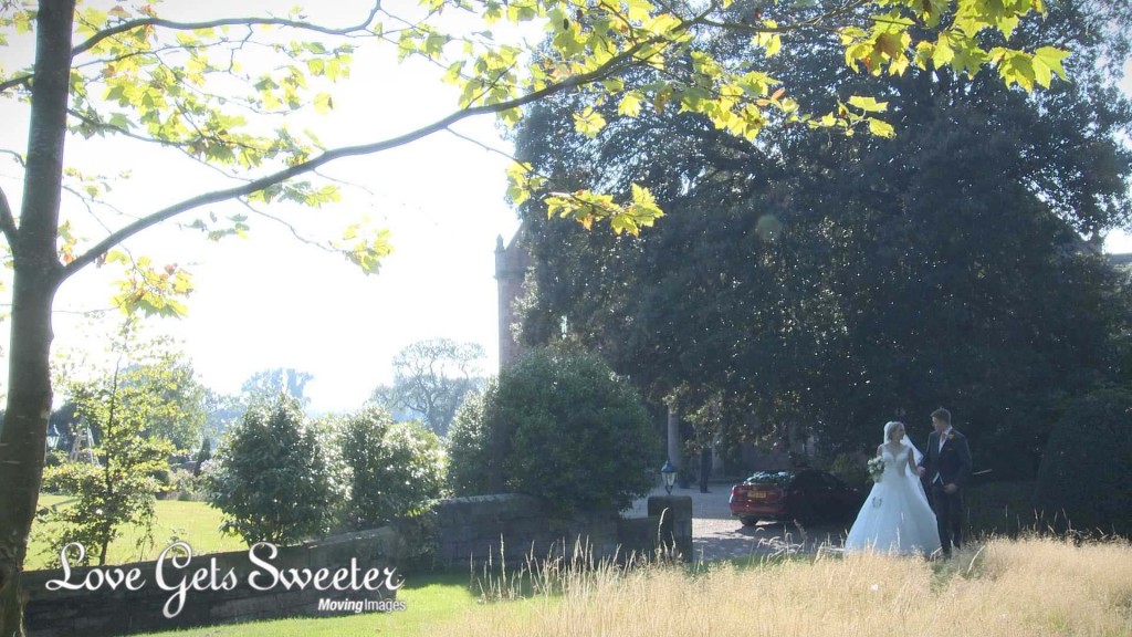 a bride and groom take a stroll around the gardens at Willington Hall Hotel estate in Tarpoley Cheshire as the videographer and photographer capture them discreetly