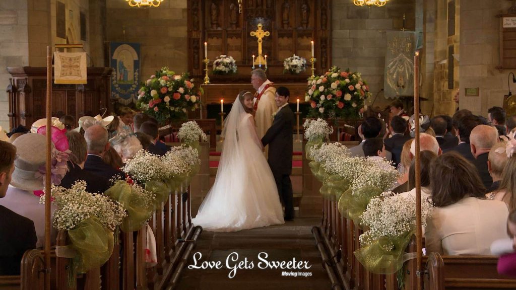 bride groom looking back to the wedding videographer after getting married at St Johns Broughton Church in Lancashire