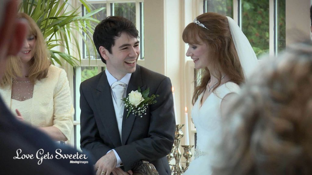 a genuine and honest smile from the groom as his bride joins him at the wedding breakfast table for their wedding reception at mitton hall 