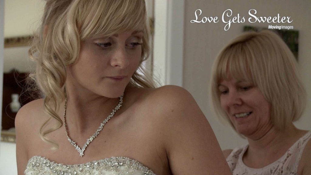 bride being helped in to wedding dress in Sandbach