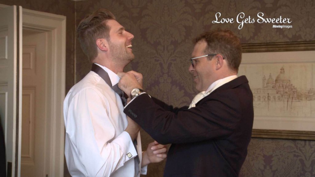 groom helping ushers get ready at Eaves Hall in Clitheroe