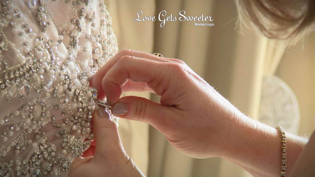 filming the bride get ready at Eaves Hall detail of back of wedding dress