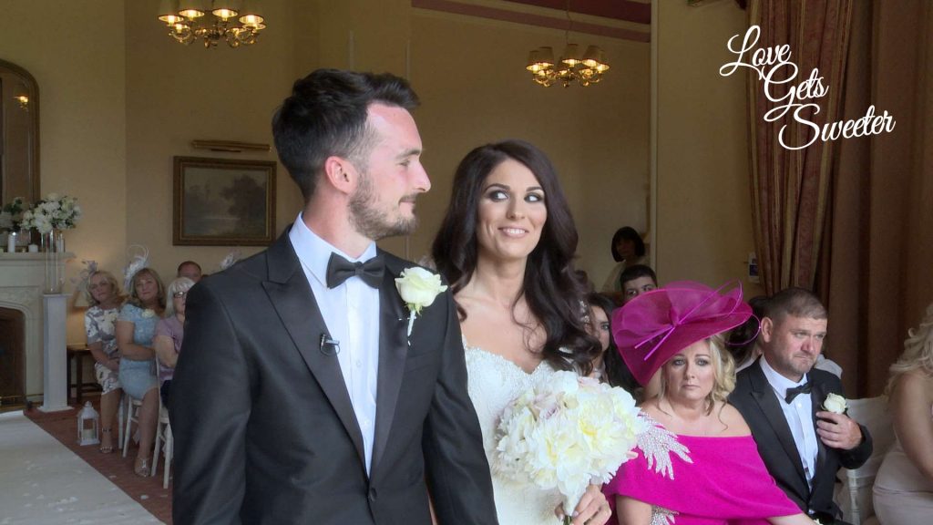 bride gives a happy, cheeky smile to her Groom during their wedding ceremony in the lake district 