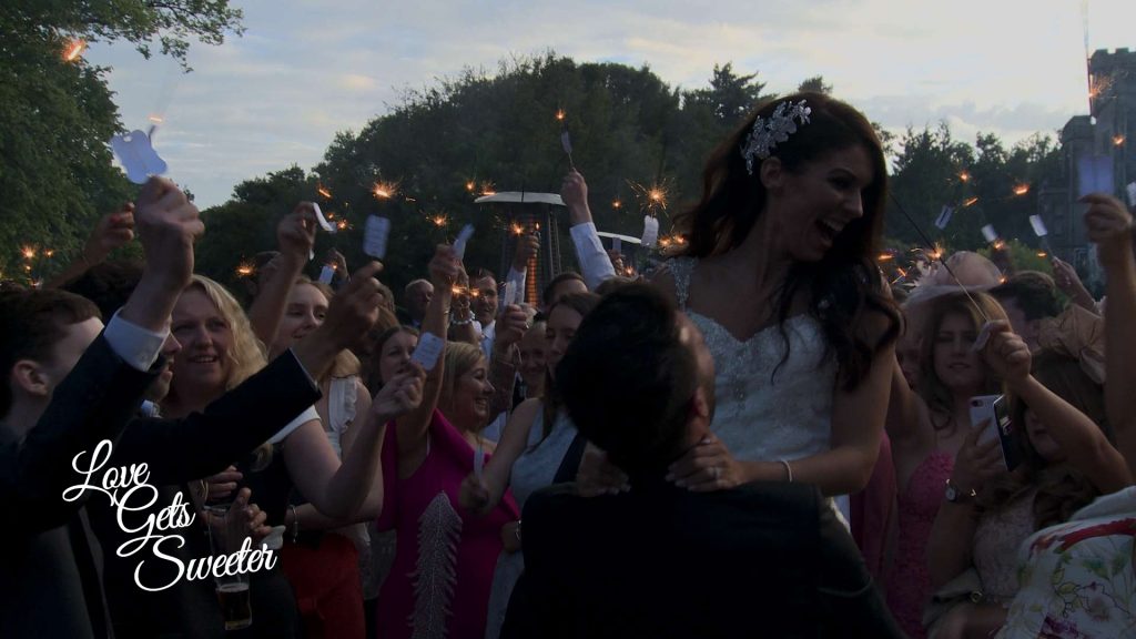 fun sparkler shot at dusk at armathwaite hall and the groom lifts the bride