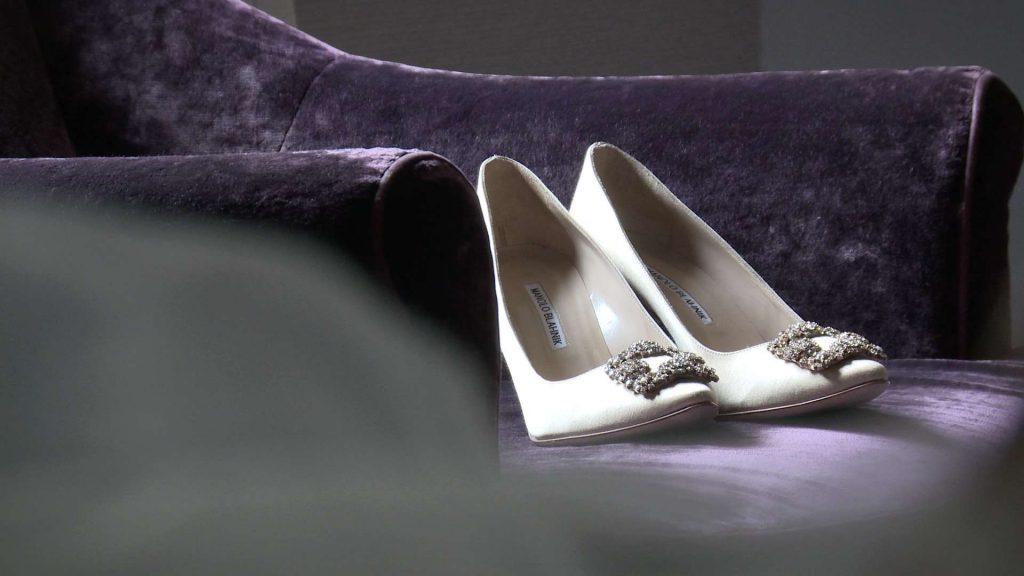 Manolo blahnik wedding shoes in champagne colour on a purple velvet chair at a wedding in drighlington