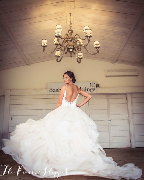 Bride dancing in her wedding dress st Bashall Barn for the photographer