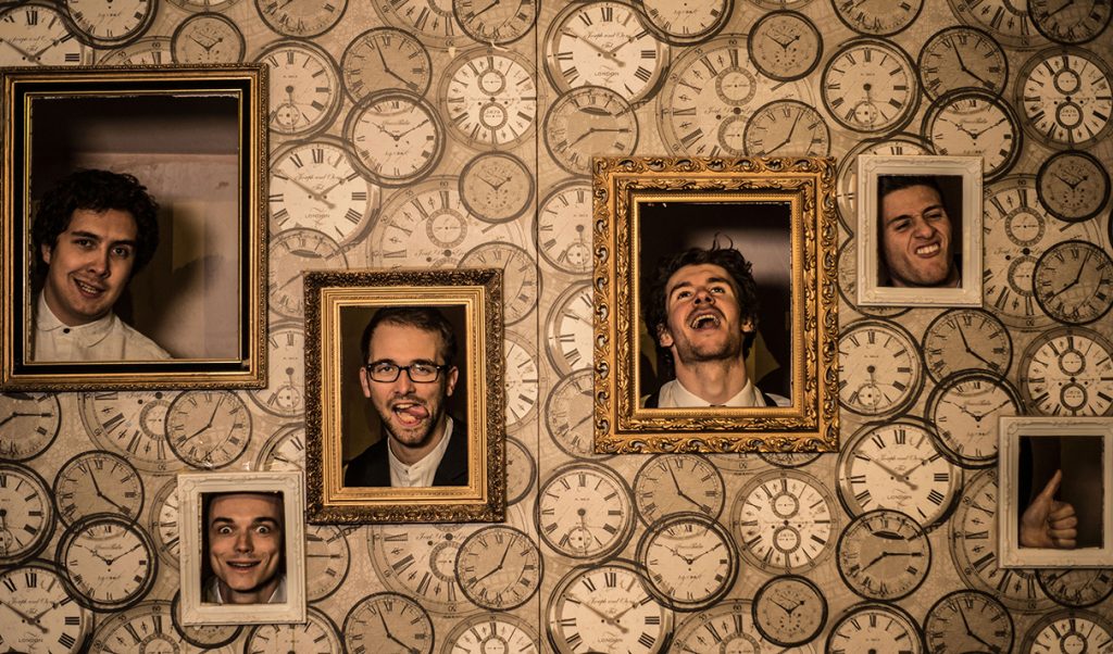 wedding band wandering wings on a promo shoot for their music agency pulling faces with their heads in picture frames