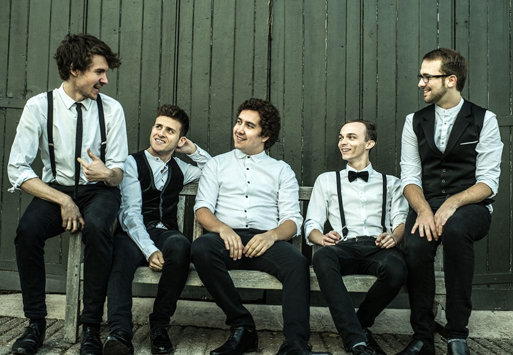 wedding band wandering wings sitting and chilling on a bench outside a green country shed