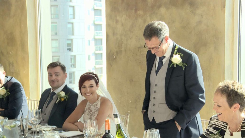 the father of the bride stands up to do his speech in the gold room at On The 7th