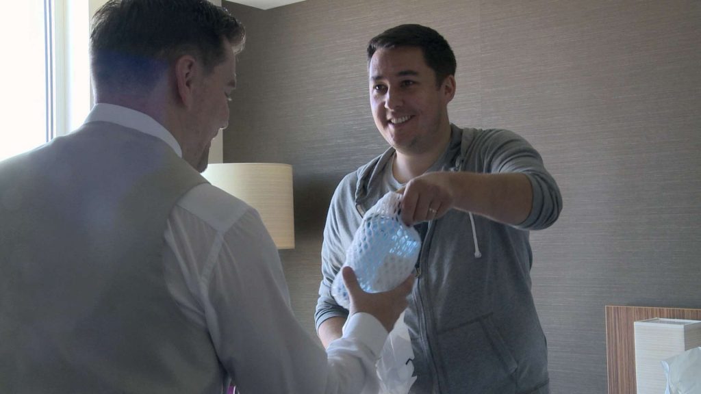 The best man shares a bottle of gin with the groom before they get married at On The 7th in Salford