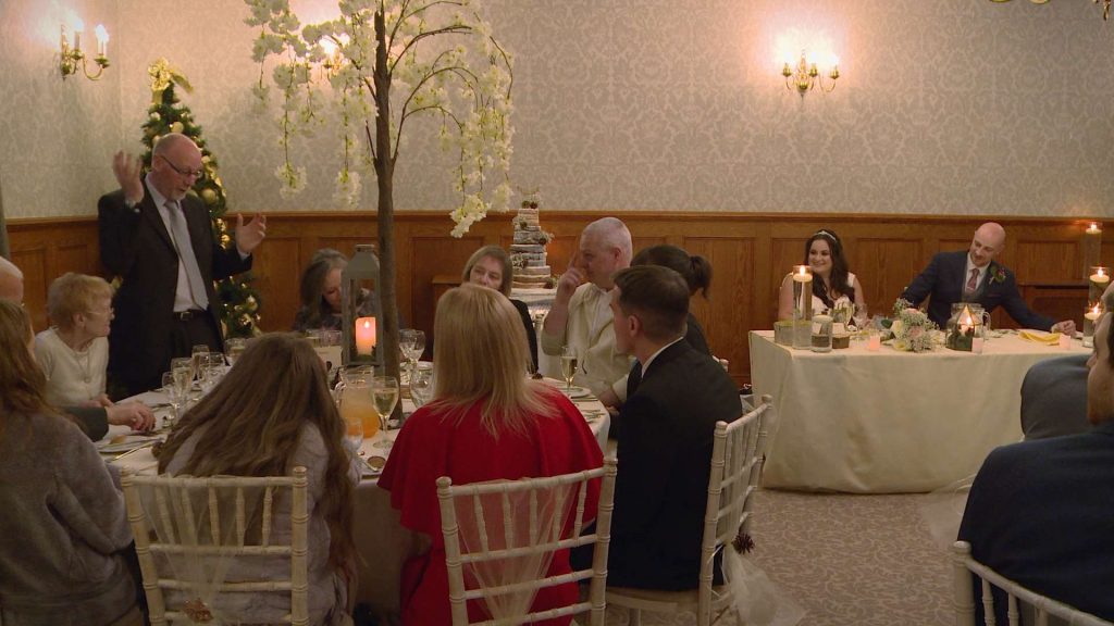 the father of the bride stands up to deliver a wedding speech at nunsmere hall on boxing day