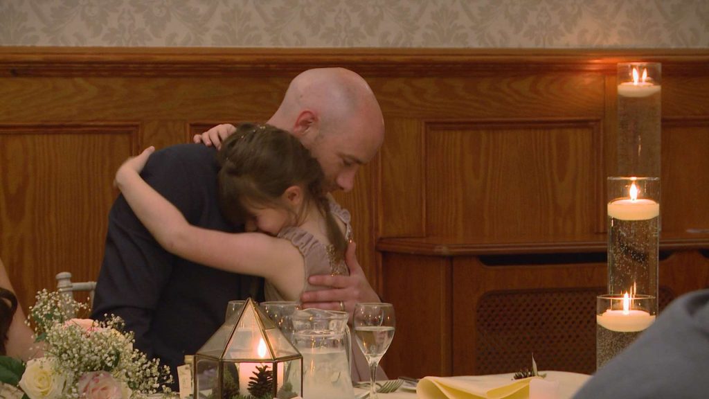 the flower girl gives her dad a big hug after his wedding speech at nunsmere hall