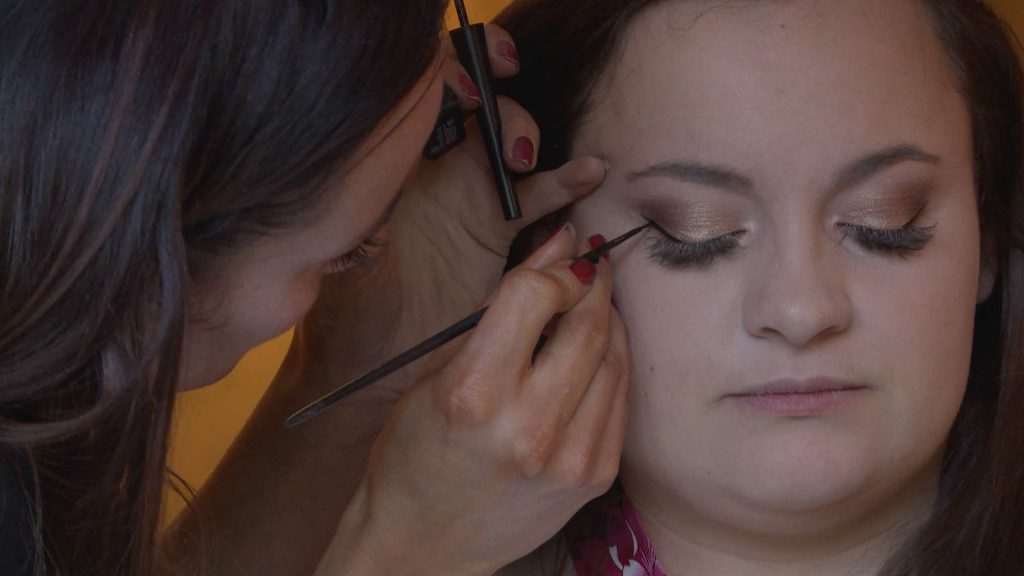 The make up artist applies the perfect feline flick for the bridal make up at a wedding in Nunsmere Hall in Northwich