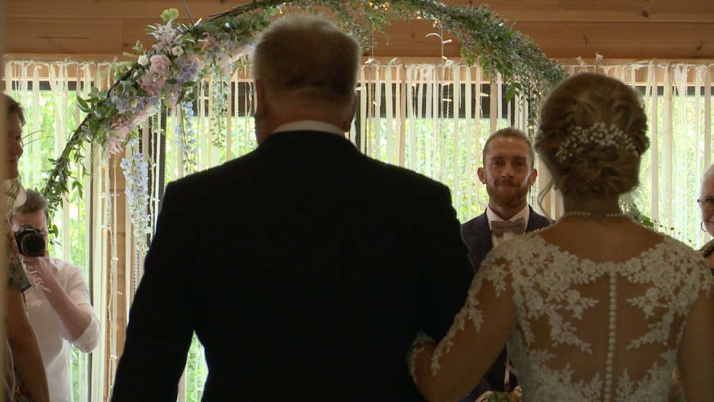 a groom get teary eyed as his bride walks down the aisle with her dad at their wedding ceremony Styal Lodge in Cheshire