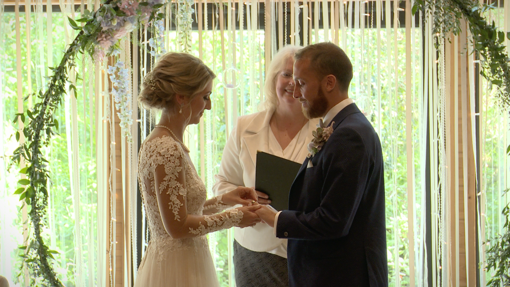 the bride and groom exchange wedding rings during their ceremony Styal Lodge in Cheshire