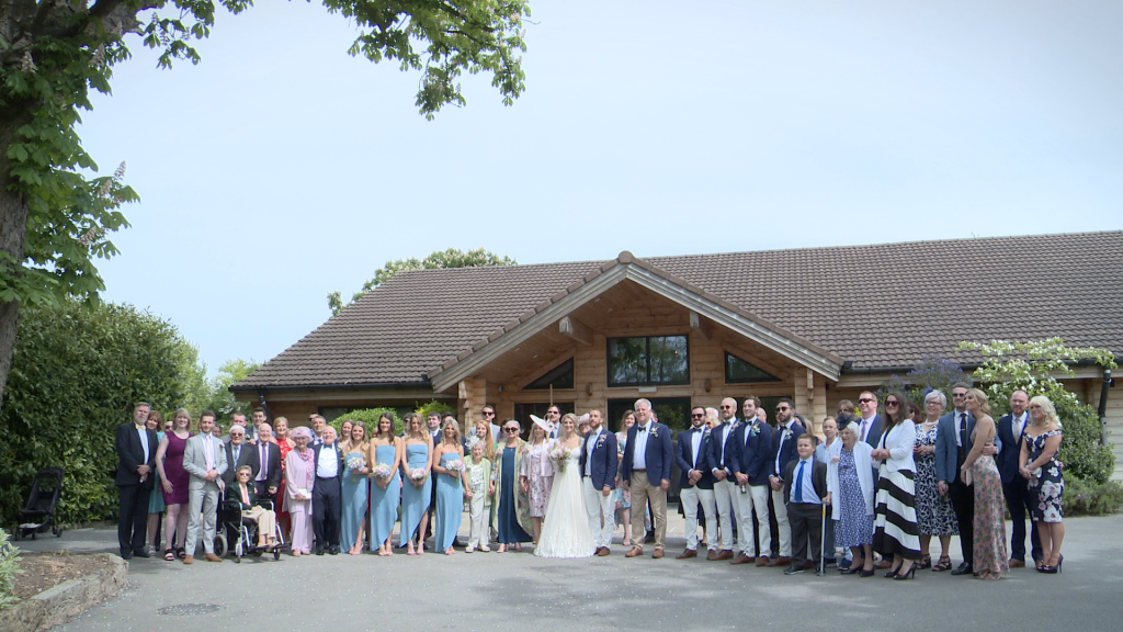a large group family wedding photo outside Styal Lodge in Cheshire by Daniel Lloyd