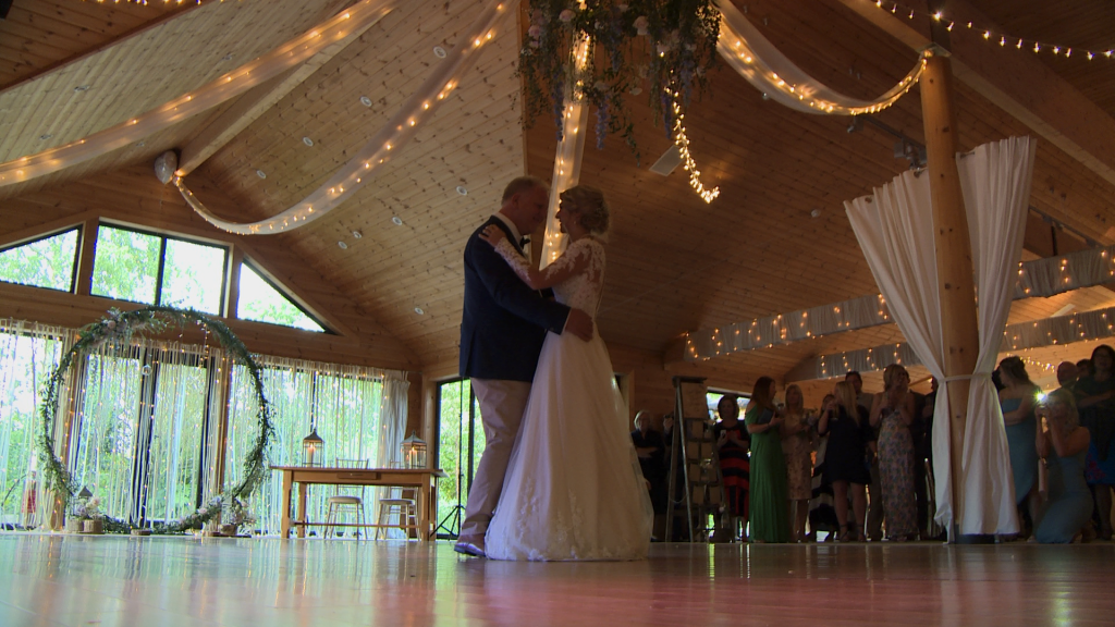 a father and daughter dance at Styal Lodge in Cheshire under fairy lights for the wedding video
