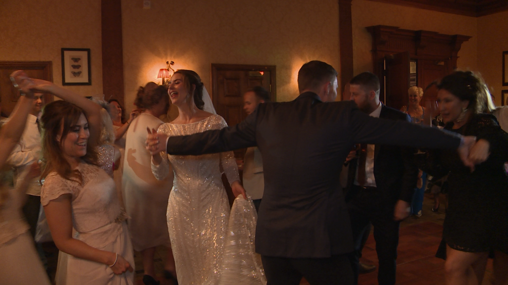 The bride sings out loud as they dance their first dance to sister sledge at their wedding reception at Inglewood manor