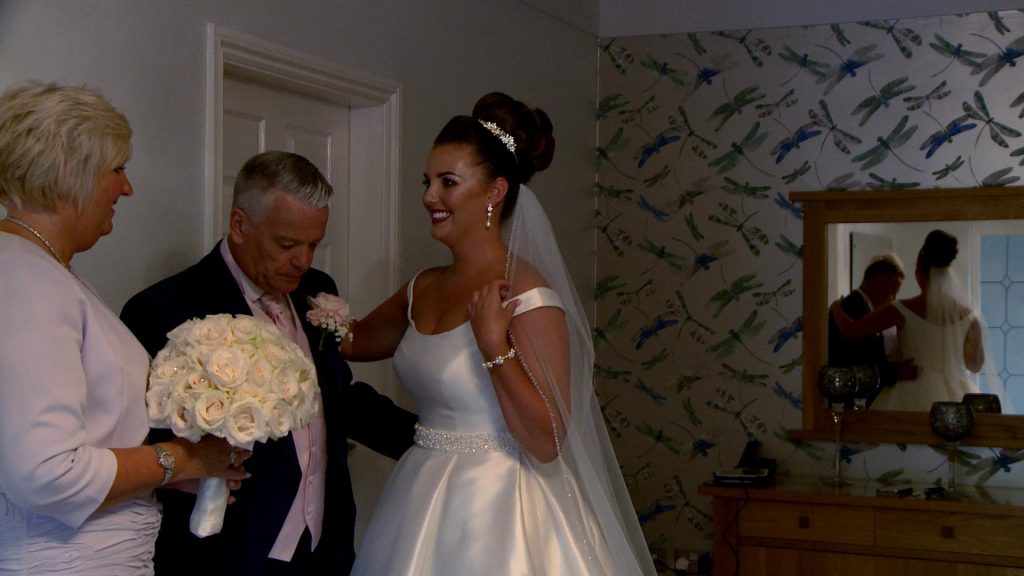 a video still of the brides dad reacting to seeing his daughter the bride for the first time