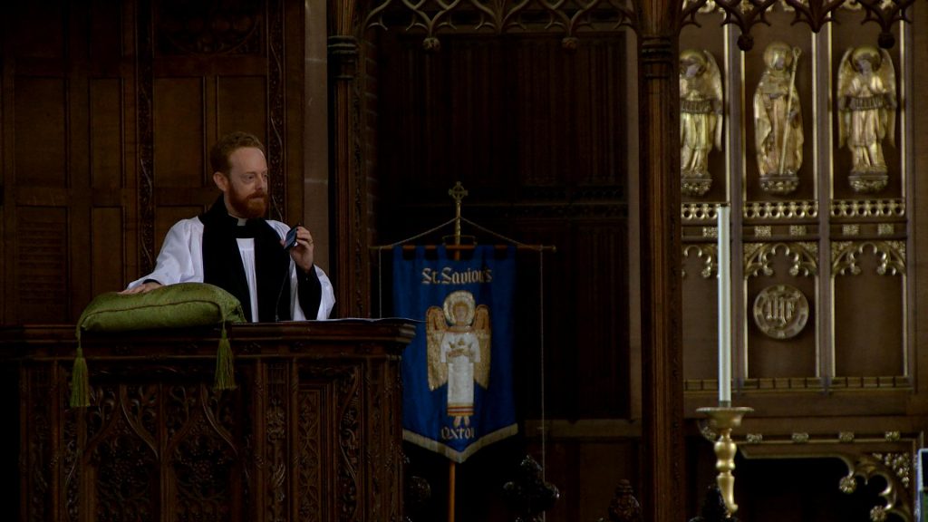 the priest nods his head to Hadaway during his church sermon at st saviours in the wirral