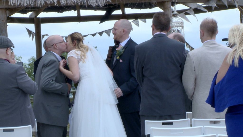 the bride kisses her dad on the cheek before she gets married to her groom at abels harp
