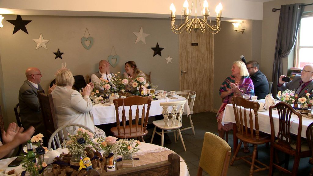 the groom covers his face in his hands after delivering his wedding speech to his guests and the wedding videographer Love Gets Sweeter