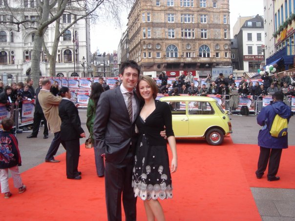 assisting editor Charlene Lilburn (now McNabb) stands with her husband on the red carpet outside the leicester square Odeon cinema for the world premiere of Mr Bean's Holiday with the famous yellow mini in the background