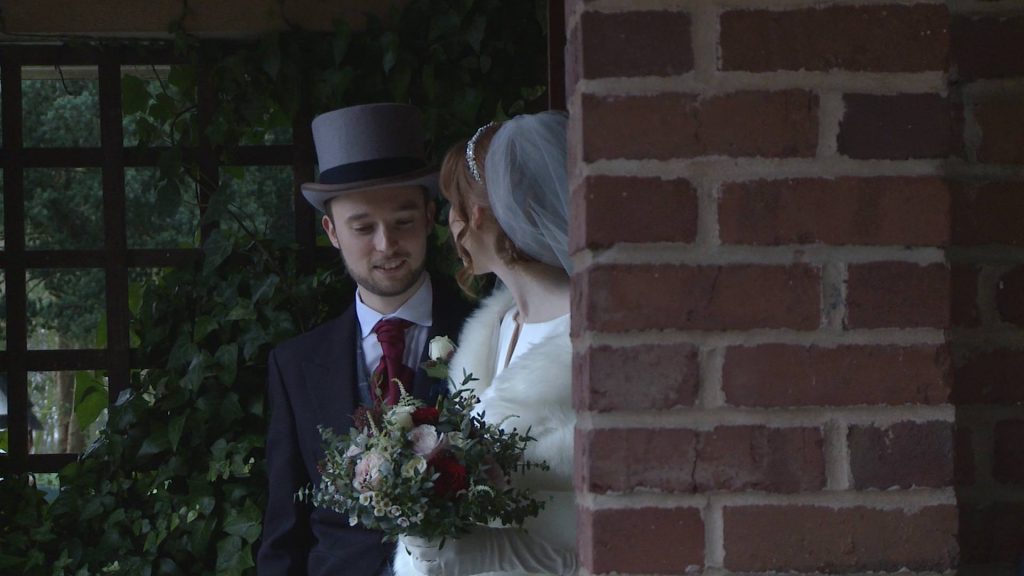 a video still of the bride and groom under the archway at The Villa at Wrea Green enjoying a quiet moment away from their guests