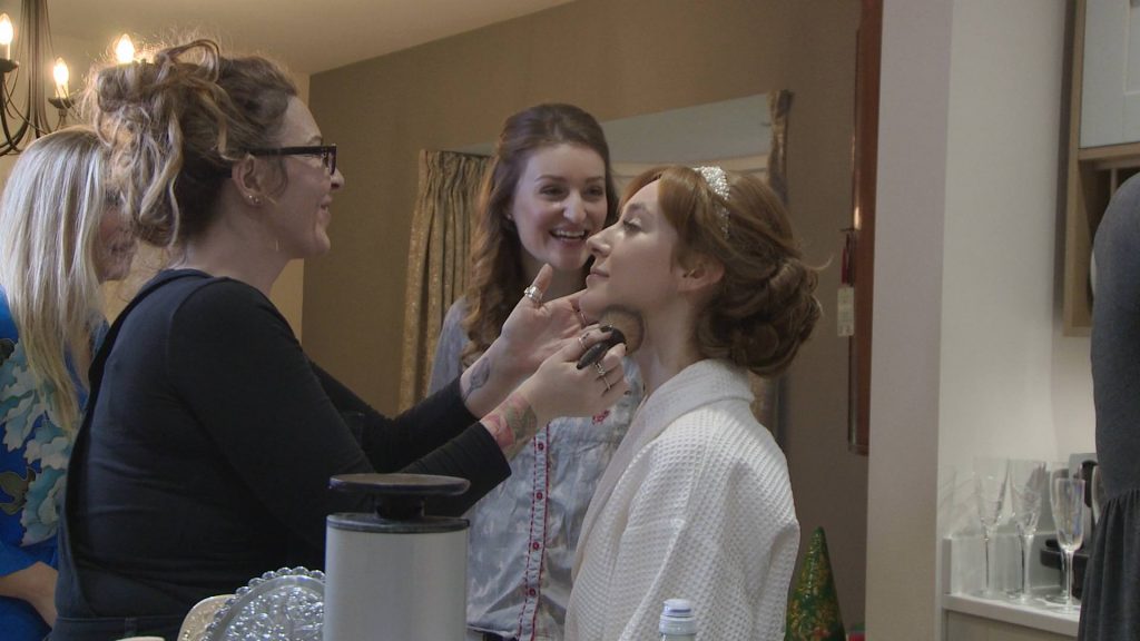 Sonara Parker make up artist laughs with a bridesmaid during a wedding morning in preston
