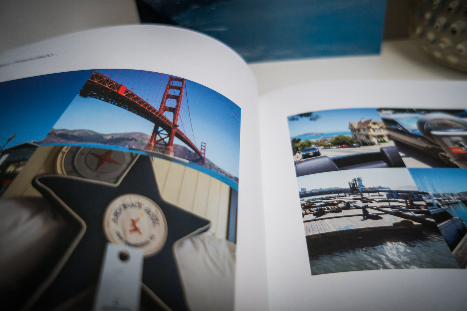 a close up of a blurb family holiday book open on the ikea side unit and you can see the iconic san Francisco bridge