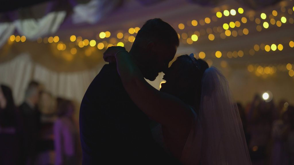 a close up silhouette shot of a bride and groom during their first dance at thornton manor lakeside