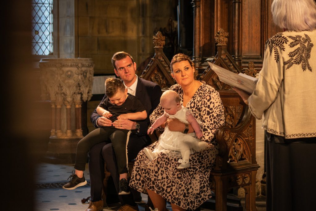 a natural moment photographed during a humanist blessing with the parents holding their children and listening to a personal reading in Lancashire