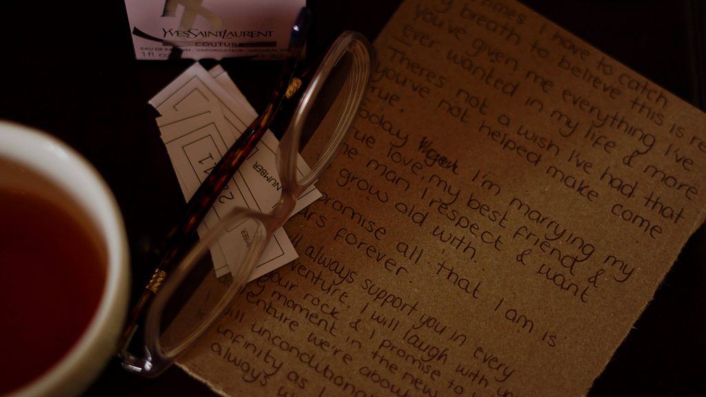 a close up shot from the wedding video of the brides personal vows on a bedside table before a wedding at Peckforton Castle in Cheshire