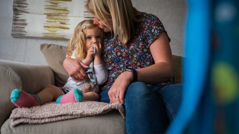natural photo of mum kissing daughter during shoot in Yorkshire