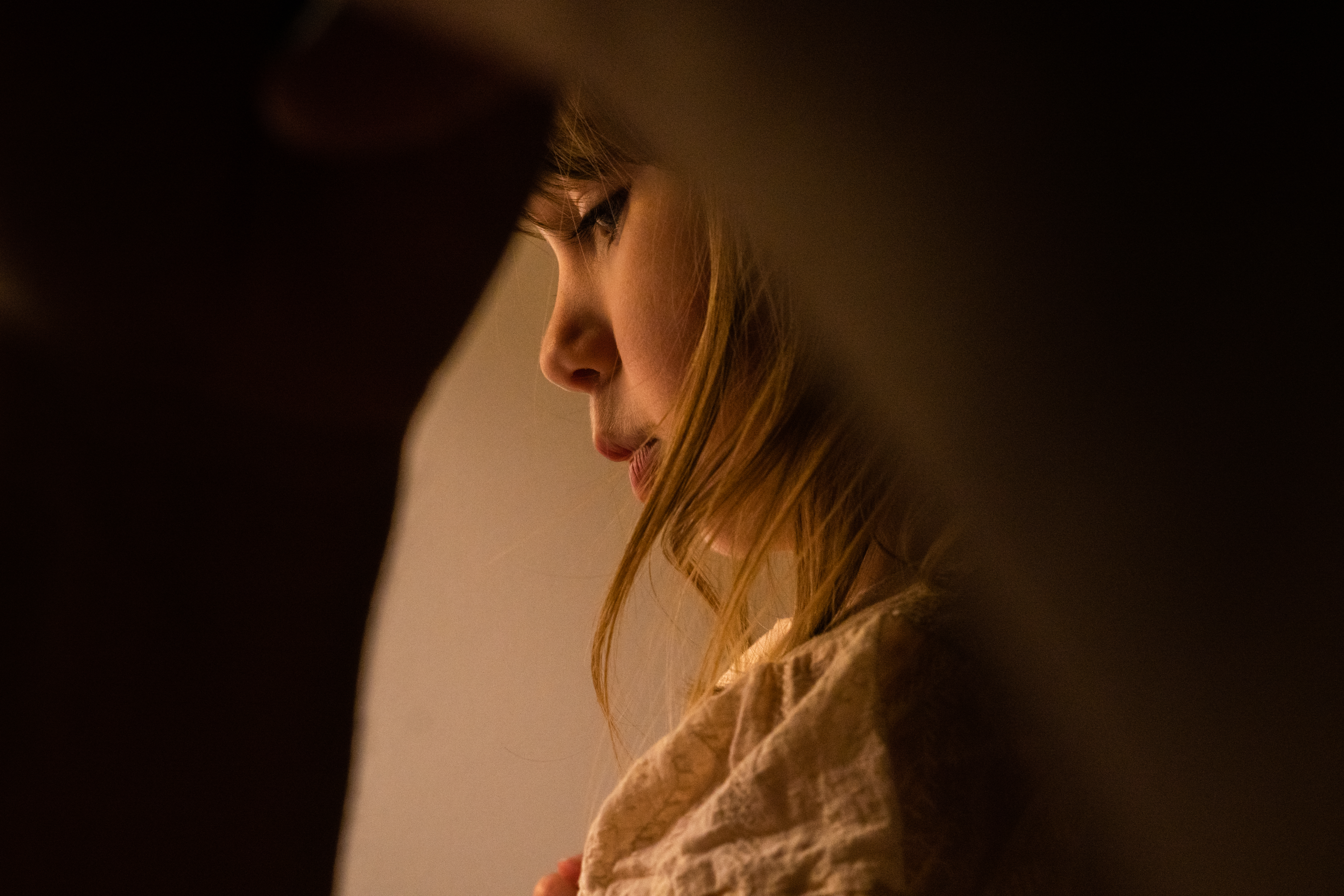 an award winning family photography portrait of a young girl through her Dads arm