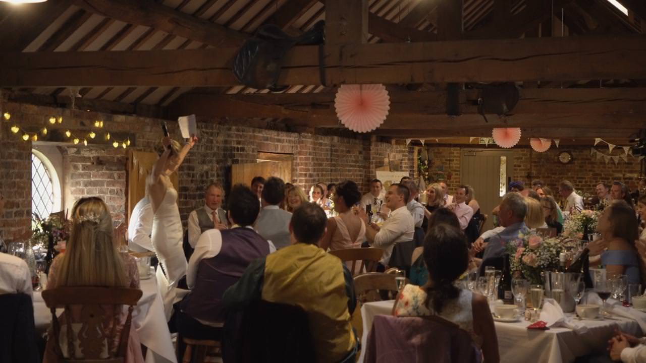 the bride stands to give a speech at their wedding at Dunham Massey