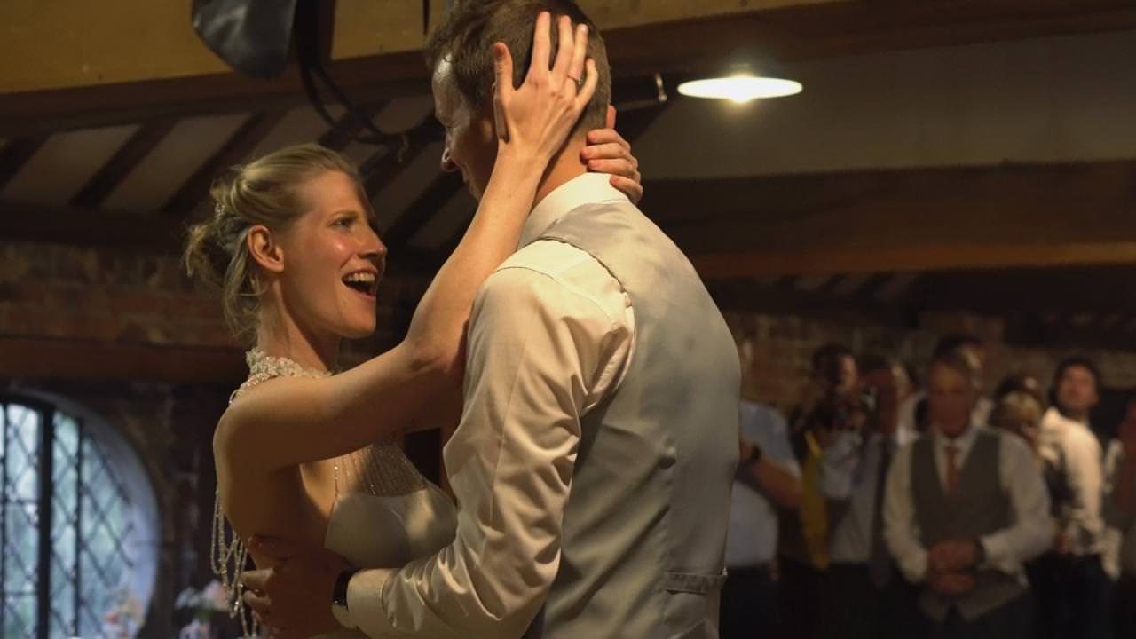 the bride sings a power ballad during their first dance at Dunham Massey