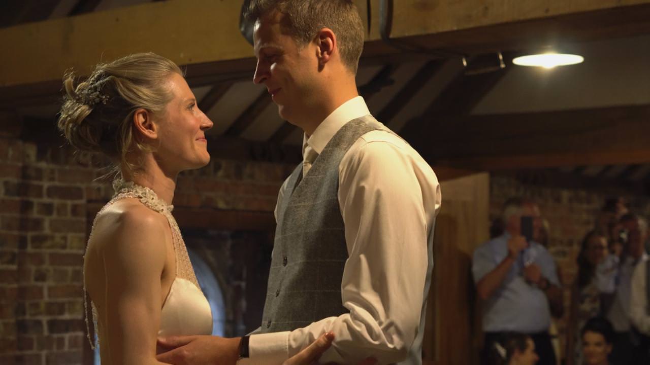 a bride and groom enjoy their first dance at the stables at Dunham Massey