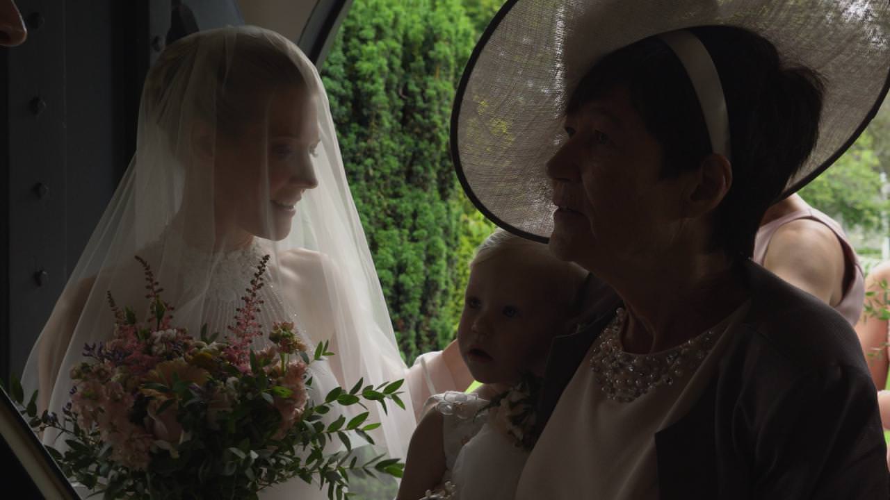 a bride in a veil stands inside St Marks Church before her wedding