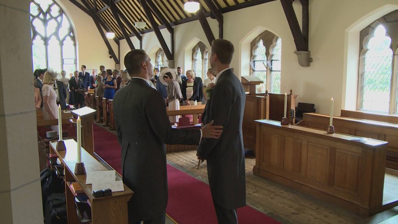 the best man reassures the groom as the bride walks down the aisle