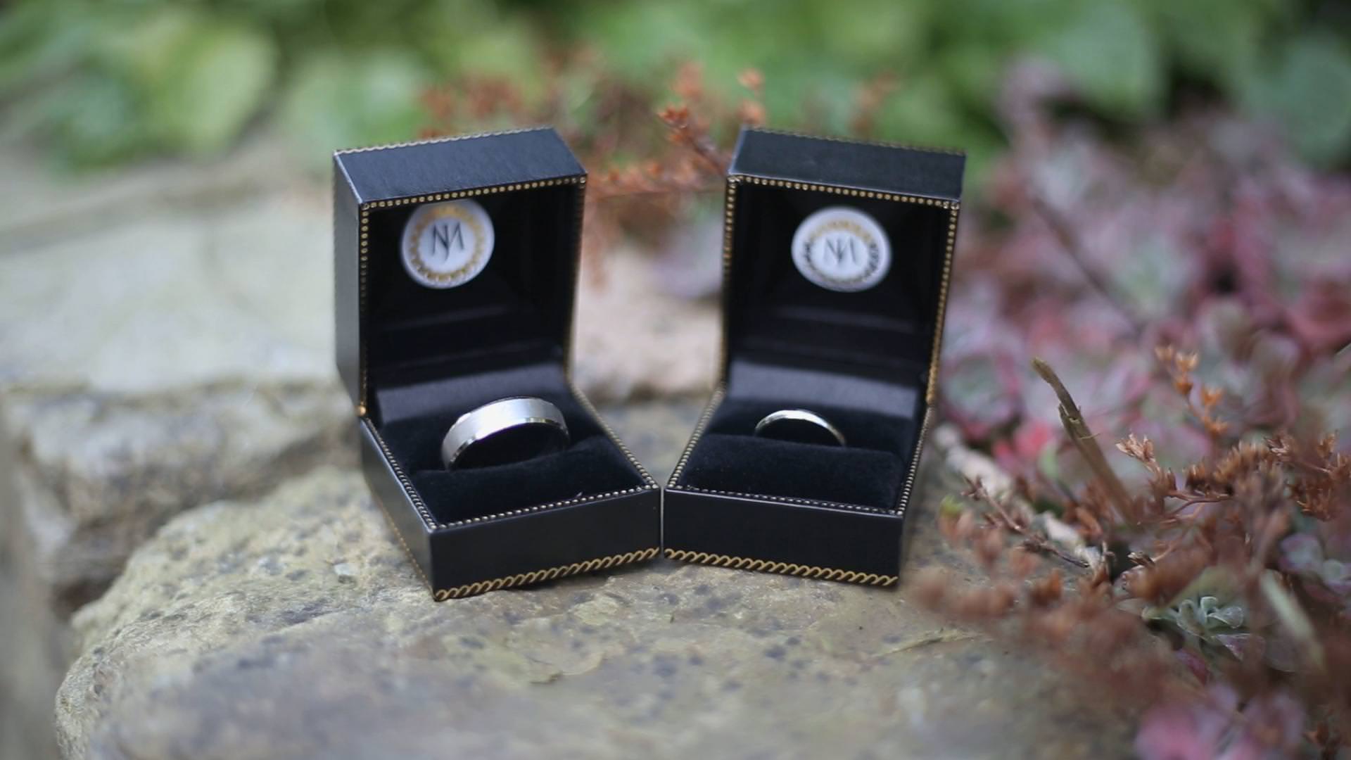 platinum wedding rings sit in their boxes before a wedding in lancashire