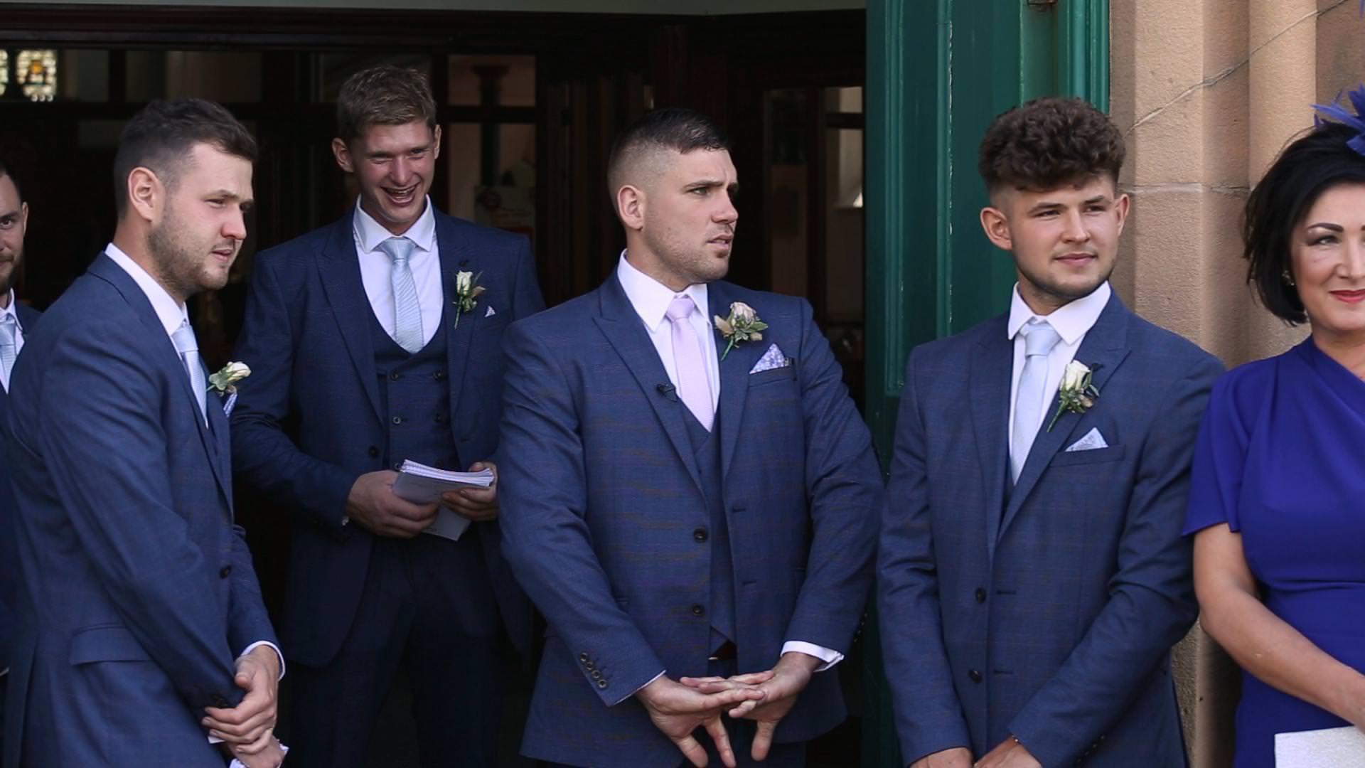 a groom waits nervously outside st johns church in burscough