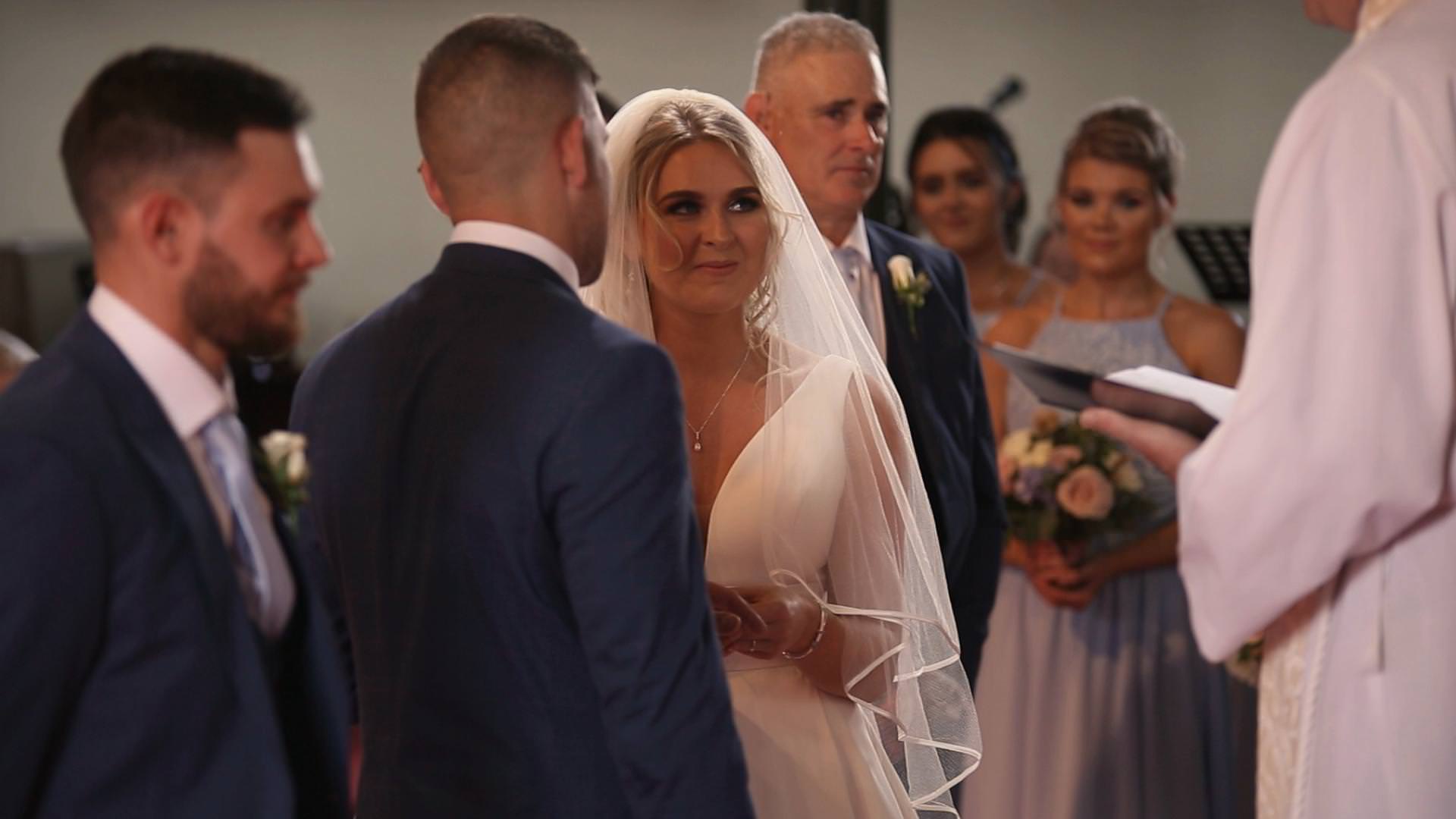 a bride and groom exchange wedding rings at St Johns church in burscough